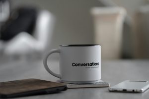 white coffee mug says conversations
